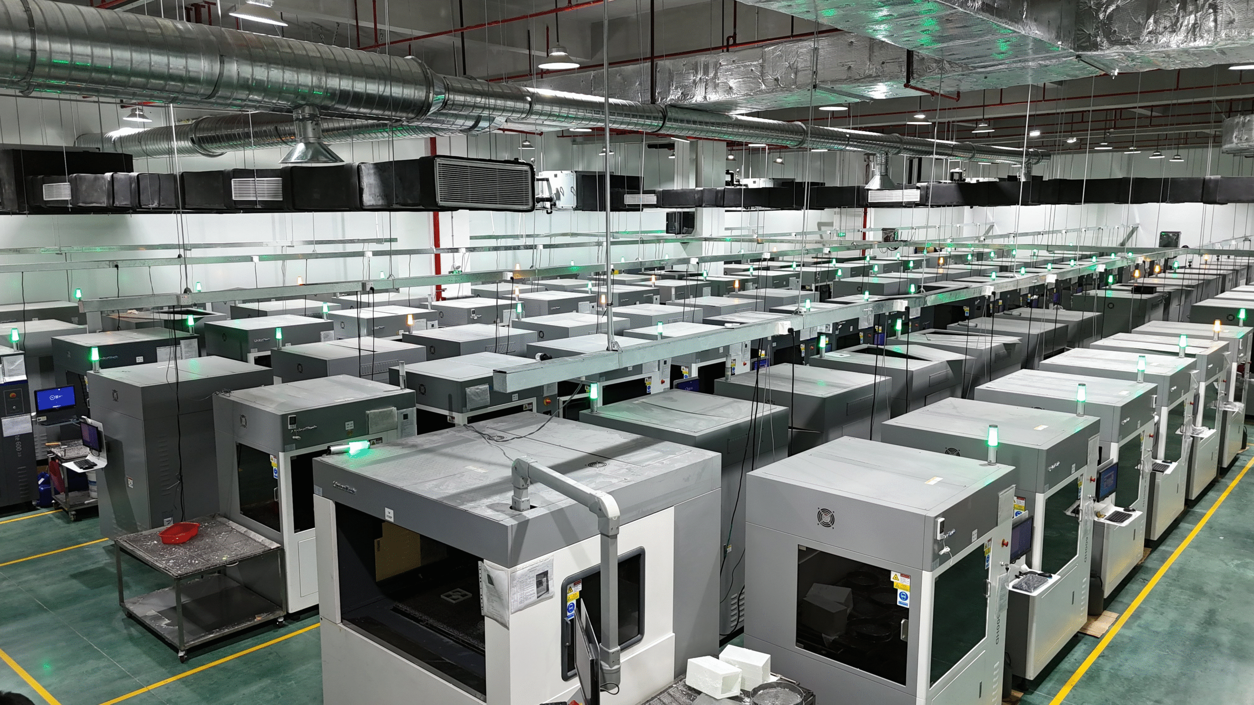 YYI Technology 3D printing factory floor with rows of industrial printers running 24/7
